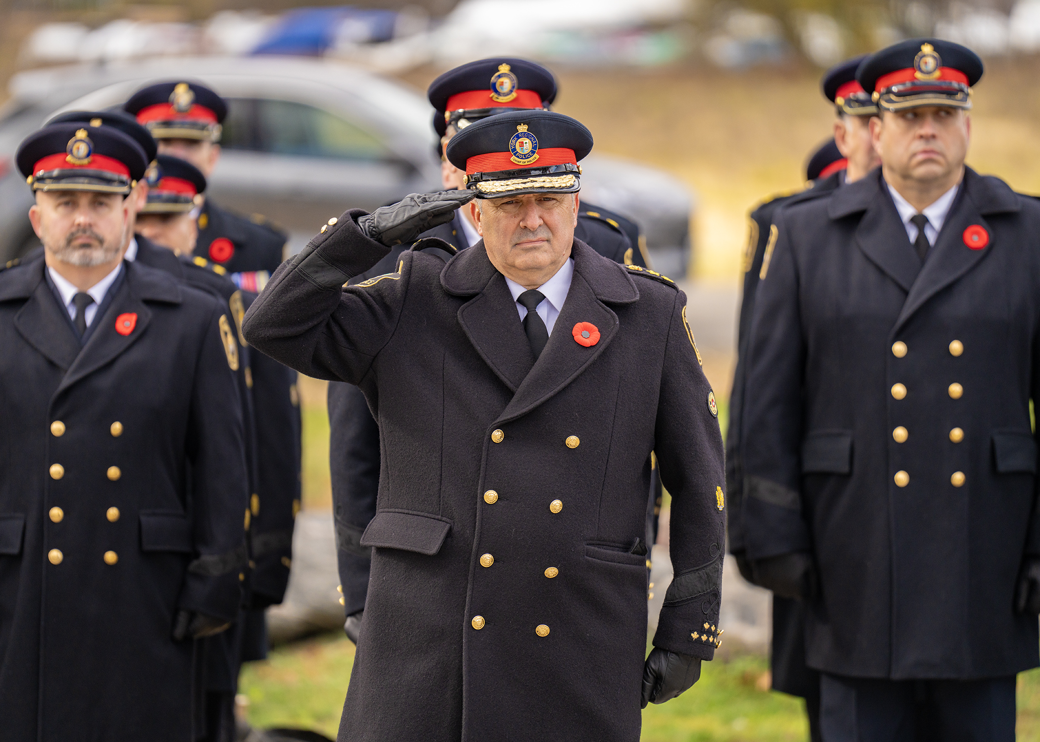 York Regional Police Chief Jim MacSween salutes at a Remembrance Day ceremony, with fellow uniformed officers