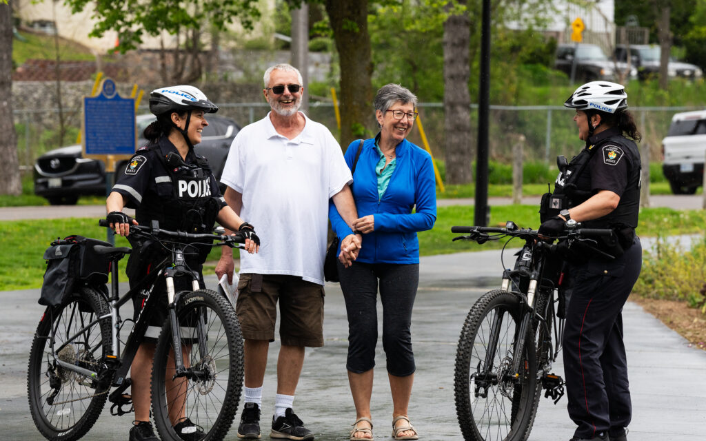 York Regional Police officers on bicycles engage with community members of all ages during Project Pedals and Pedestrians, promoting safe walking, biking, and driving practices.