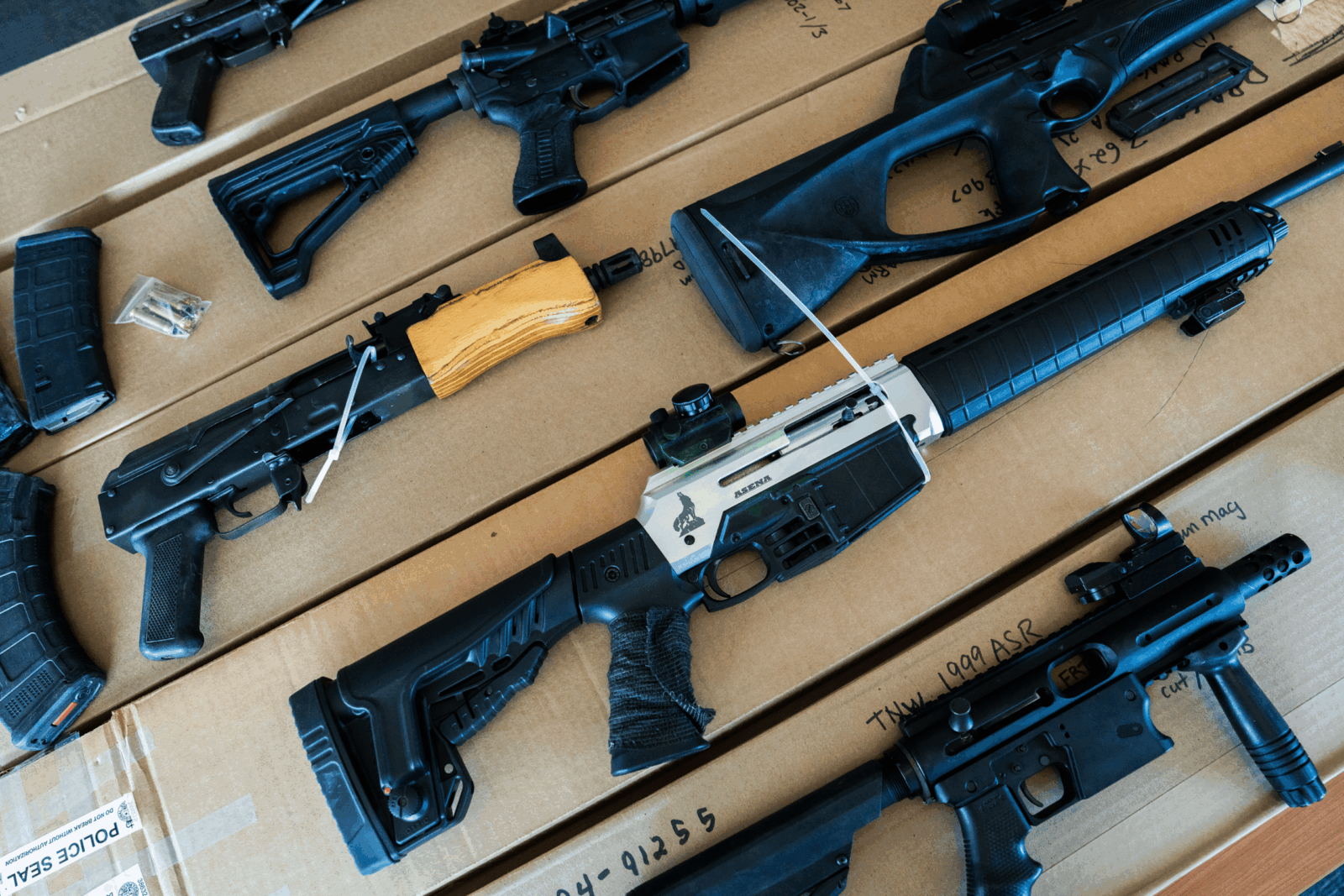 Firearms, magazines, and bullets recovered by York Regional Police displayed during a press conference.
