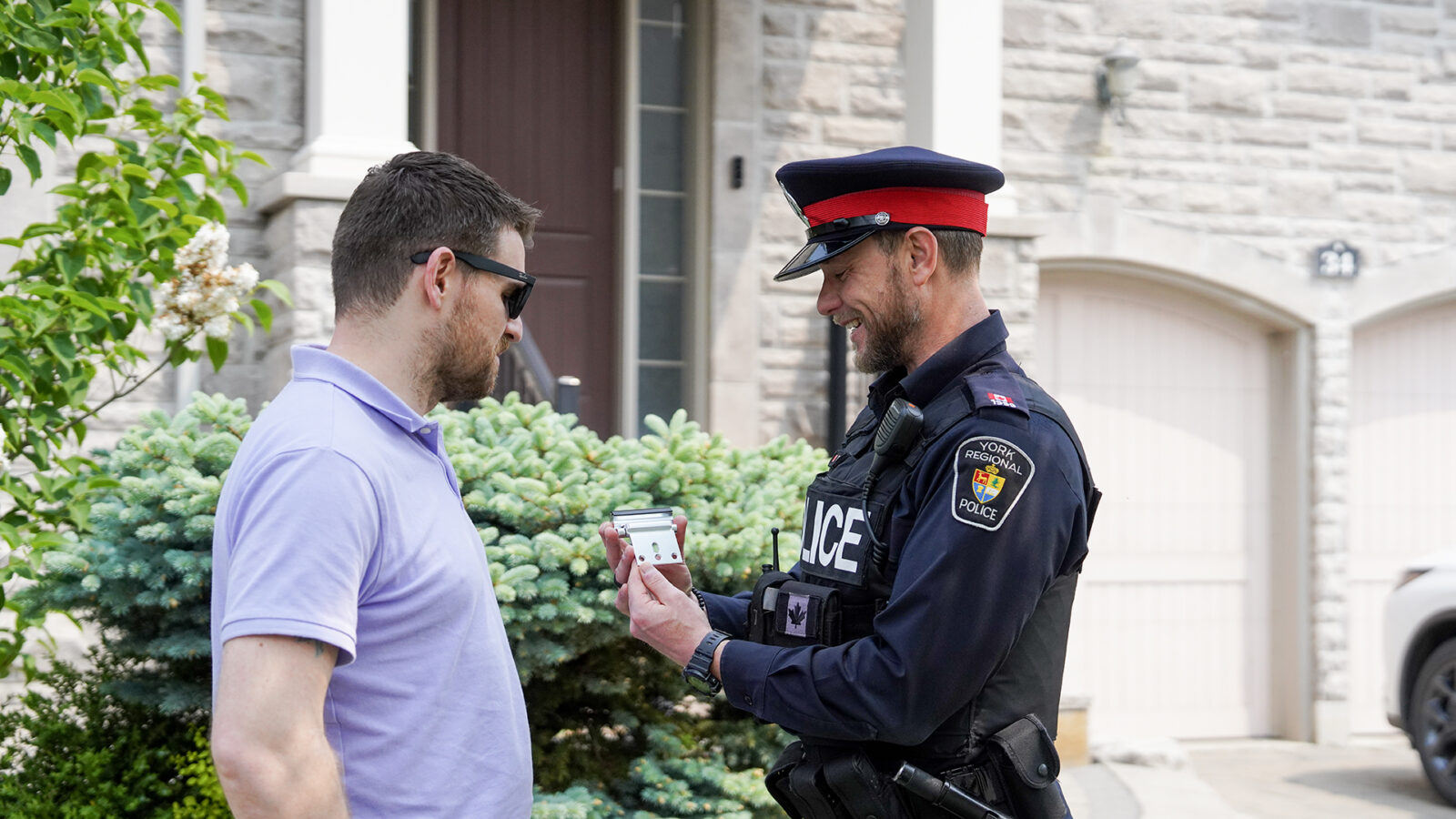 York Regional Police officer speaking with a citizen about door safety tips